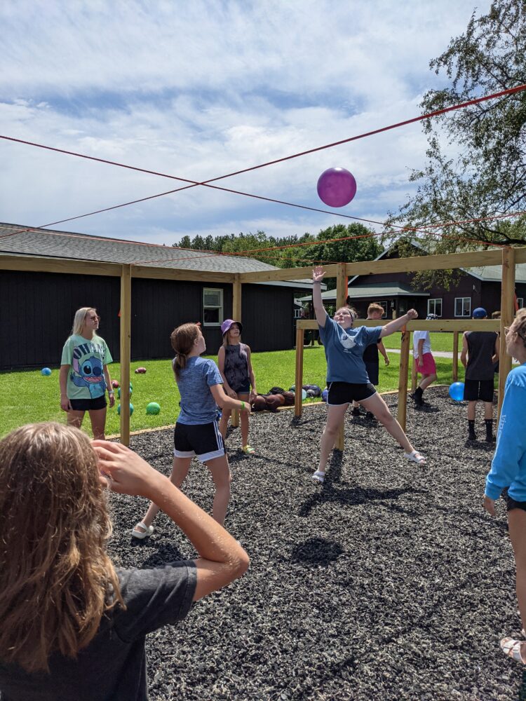 Photo of a group of people playing 9 square in the air