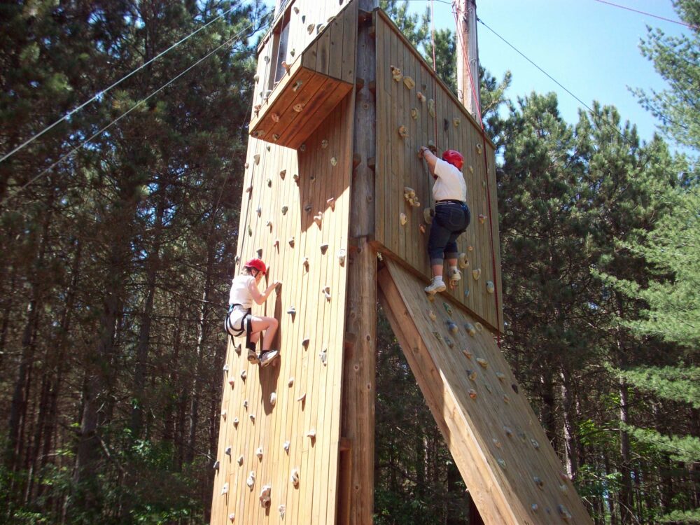 Photo of two people climbing on the climbing tower