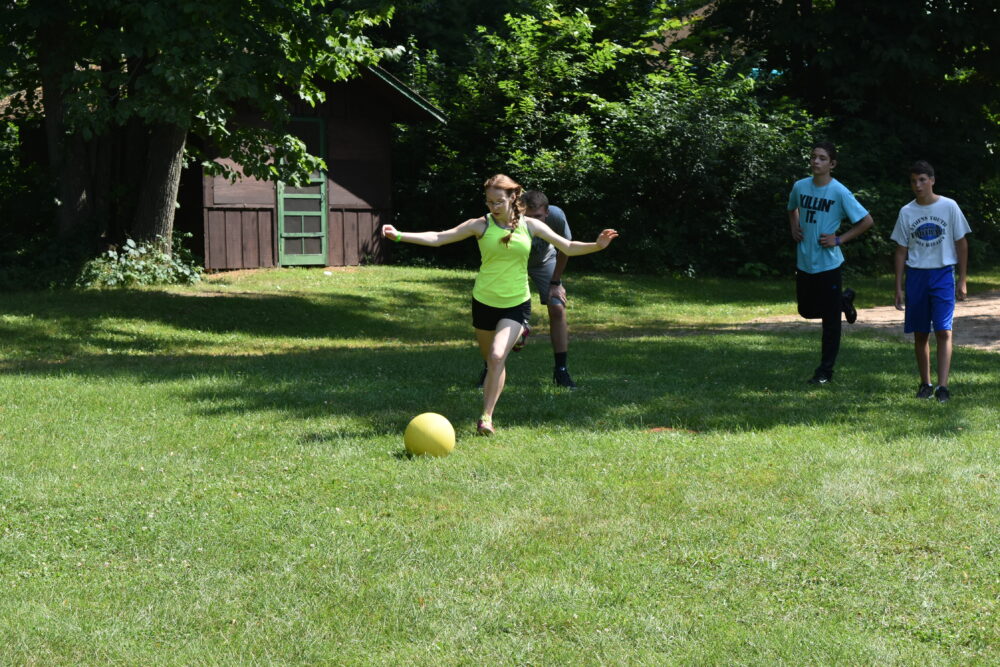 Photo of camper playing kickball