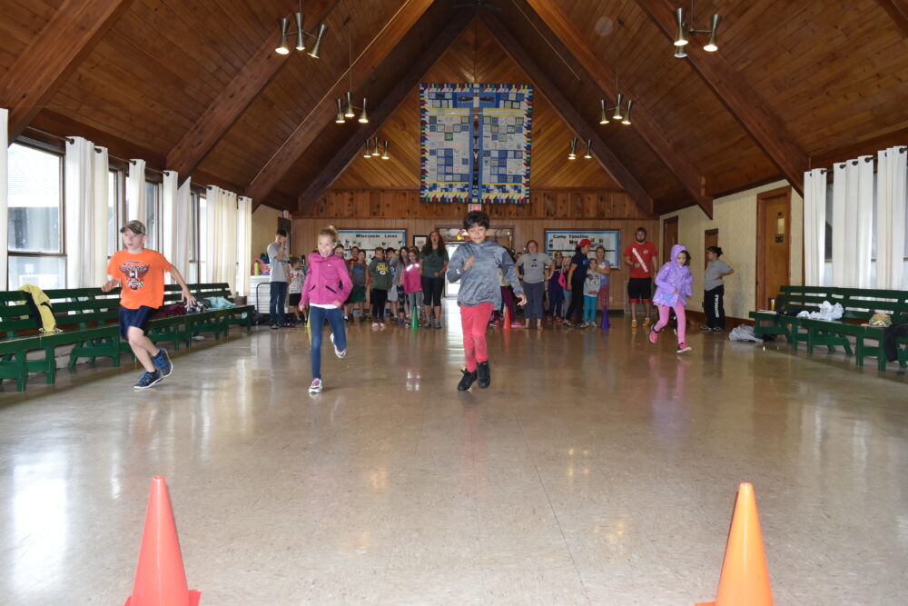 Photo of youth running while playing indoor game