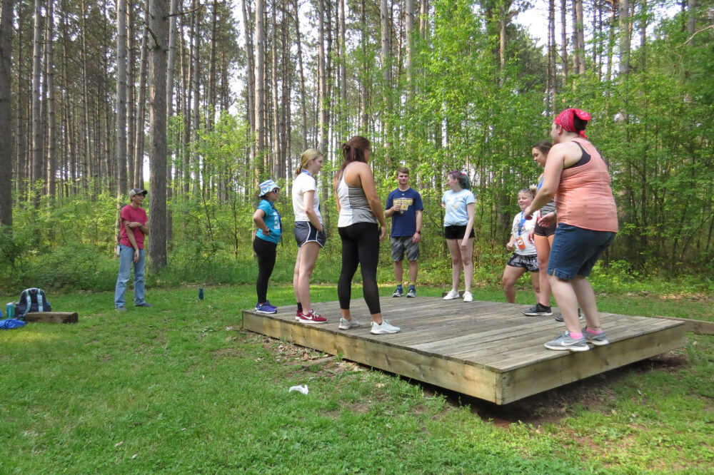 Photo of a group standing on the whale watch initiatives activity in the woods