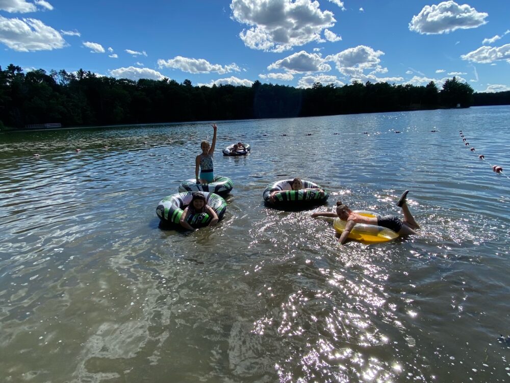 Photo of youth on inner tubes on Lions Lake